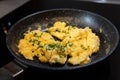 Scrambled eggs in cooking pan. Process of cooking scrambled eggs Royalty Free Stock Photo