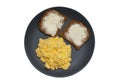 Scrambled eggs with dark bread isolated on white