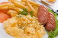 Scrambled eggs with french fries and sausage