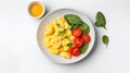 Scrambled eggs with fresh spinach and cherry tomatoes create vibrant and healthy breakfast option. dish is garnished with herbs Royalty Free Stock Photo