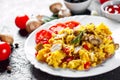 Scrambled eggs with mushrooms and vegetables in white plate Royalty Free Stock Photo