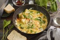 Scrambled eggs, omelet with spinach and broccoli and cheese in a pan close- up Royalty Free Stock Photo