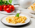 Scrambled eggs, Omelette. Breakfast with pan-fried eggs, cup of Royalty Free Stock Photo