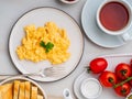 Scrambled eggs, Omelette. Breakfast with pan-fried eggs, cup of Royalty Free Stock Photo