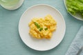 Scrambled eggs, omelette. Breakfast with pan-fried eggs. Texture of omelet on white plate