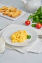 Scrambled eggs, Omelette. Breakfast with pan-fried eggs, glass of milk, tomatoes on white background. Vertical