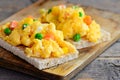 Scrambled eggs omelette. Homemade scrambled eggs omelette with vegetables on crispy bread toasts. Healthy eating. Rustic style Royalty Free Stock Photo