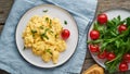 Scrambled eggs, omelette, long banner. Breakfast with pan-fried eggs, cup of tea, tomatoes on old wooden table Royalty Free Stock Photo