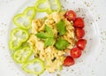 Scrambled eggs with paprika, cherry tomatoes and celery leaves Royalty Free Stock Photo