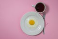 Scrambled eggs on a pink background. Fried eggs on a white plate. Royalty Free Stock Photo