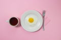 Scrambled eggs on a pink background. Fried eggs on a white plate. Royalty Free Stock Photo