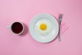 Scrambled eggs on a pink background. Fried eggs on a white plate. Royalty Free Stock Photo