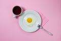 Scrambled eggs on a pink background. Fried eggs on a white plate. Royalty Free Stock Photo