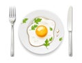 Scrambled eggs. Plate, fork and knife. Breakfast serving