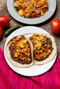 Scrambled eggs and refried beans tacos on wooden background. Mexican food