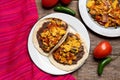 Scrambled eggs and refried beans tacos on wooden background. Mexican food
