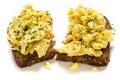 Scrambled eggs on rustic wholemeal bread, isolated on a white ba Royalty Free Stock Photo