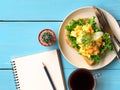 Scrambled eggs sandwich breakfast with empty notebook. Royalty Free Stock Photo