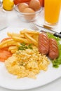 Scrambled eggs with sausage and french fries