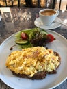 Scrambled Eggs with Sourdough Bread, Cheddar Cheese, Bacon Slices served with Salad Royalty Free Stock Photo