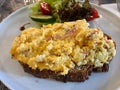 Scrambled Eggs with Sourdough Bread, Cheddar Cheese, Bacon Slices served with Salad Royalty Free Stock Photo