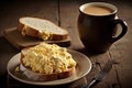 scrambled eggs on toast bread and coffee cup on wooden table Royalty Free Stock Photo