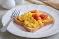 Scrambled eggs with tomato on toasted whole wheat bread Royalty Free Stock Photo