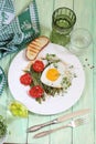 Scrambled eggs with tomatoes and green beans on green wooden background Royalty Free Stock Photo