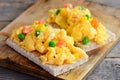 Scrambled eggs with vegetables on crispy bread. Healthy scrambled egg omelet. Easy homemade cooking. Rustic style. Closeup Royalty Free Stock Photo