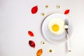 Scrambled eggs on a white plate and a bright white table Royalty Free Stock Photo