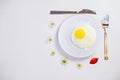 Scrambled eggs on a white plate and a bright white table Royalty Free Stock Photo