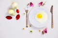 Scrambled eggs on a white plate and a bright white table Royalty Free Stock Photo