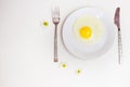 Scrambled eggs on a white plate and a bright white table Royalty Free Stock Photo