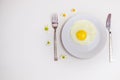 Scrambled eggs on a white plate and a bright white table Royalty Free Stock Photo