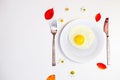 Scrambled eggs on a white plate and a bright white table Royalty Free Stock Photo