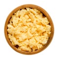 Scrambled eggs in wooden bowl over white