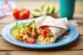 scrambled tofu burrito with salsa and vegan cheese