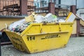 Scrap and rubbish in yellow dumpster container