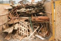 Scrap wood in a recycling skip.