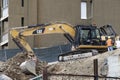 Scraper bulldozer. Construction site. Houses.