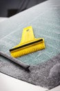 Scraper using to scrape ice from car window, winter problems in transportation concept Royalty Free Stock Photo