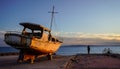 A scrapped yacht beside the Aegean Sea in sunset, Athens, Greece Royalty Free Stock Photo