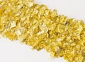 Scraps of gold foil in diagonal Royalty Free Stock Photo