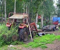 Scrapyard with old red tractor wreck with front loader Royalty Free Stock Photo