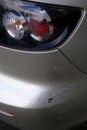 Scratched back bumper on the grey metallic car. Closeup image of damaged back bumper on the car. Photo for the insurance