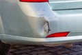 Scratched car bumper with deep damage to the paint, damaged by accident, close-up Royalty Free Stock Photo