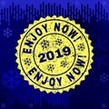 Scratched ENJOY NOW! Stamp Seal on Winter Background Royalty Free Stock Photo