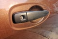 Scratched nails in the brown car door handle