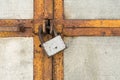 The scratched old padlock closes gray metal door or gate, abstract background Royalty Free Stock Photo