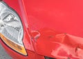 Scratches And Rusty Dent On Front Of Red Car